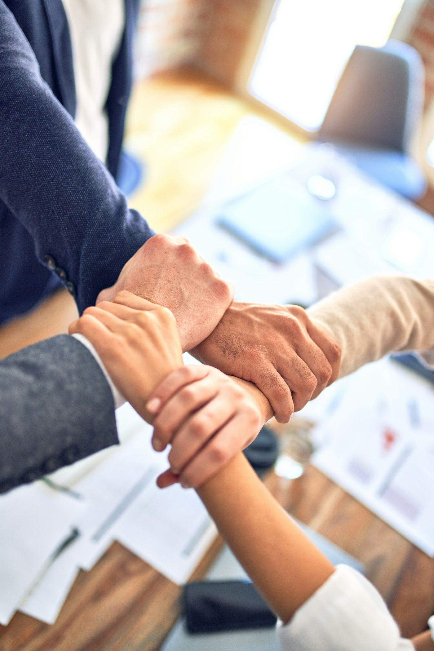 Team members gripping wrists in a unity gesture